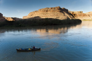 Man in a canoe on a desert river
