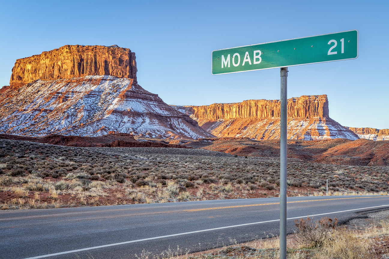 Moab 21 miles road sign near Casttle Valley in Utah, winter sunrise scenery - travel and recreation concept