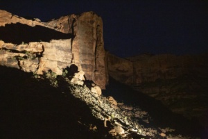 Colorado River canyon wall lit up at night during the Moab Sound and Light Show