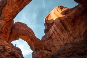 Tourists enjoying spectacular vistas at The Windows Section, Arches National Park sightseeing.