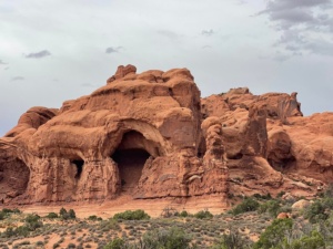 Arches Pavement Tour group admiring natural rock arches near Moab, Utah.